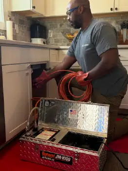 Professional drain cleaning service clearing a clogged household drain