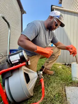 Hydro jetting equipment used to scour buildup from drain pipes