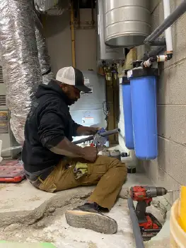 Water filtration system installation process showing new filter materials