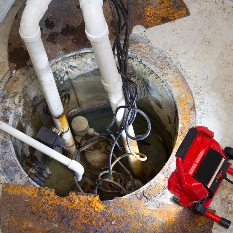 sump pump repairs being done in a home's basement