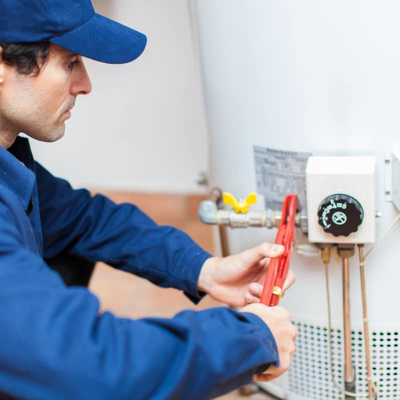 plumber fixing a hot water heater