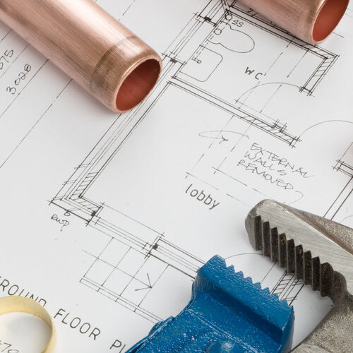 close-up of plumber plans and tools