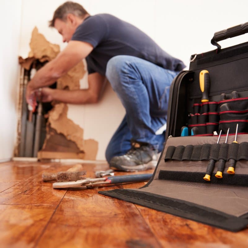 plumber repairing a burst pipe