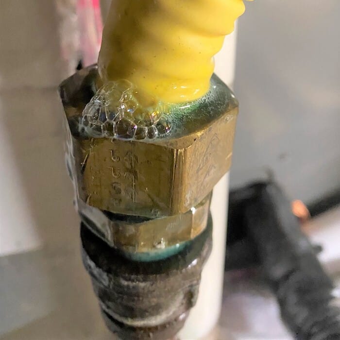 A leaking gas valve with bubbles