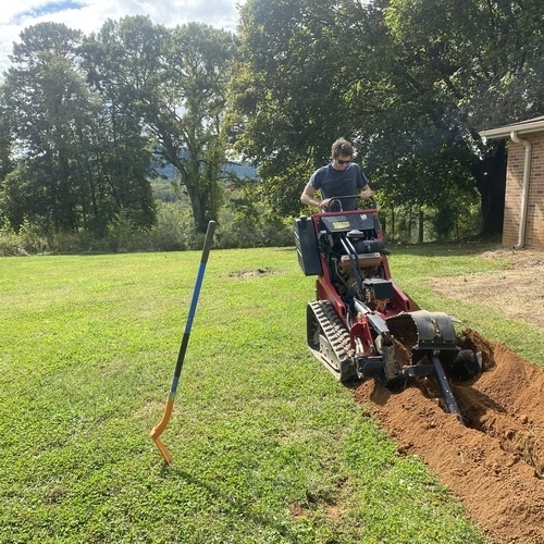 Plumber Digs Trench for Sewer Line Repair.