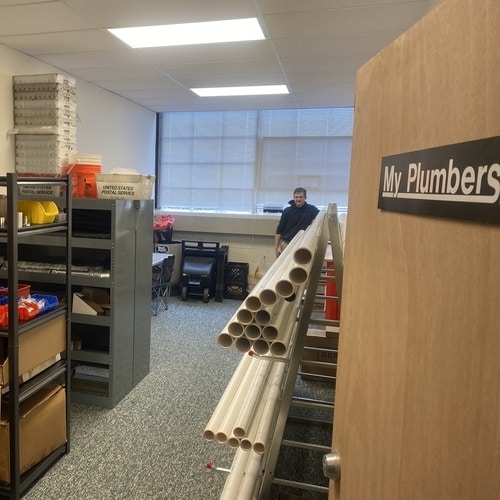 A Plumber in an Office With Supply of Pipes and other Materials.