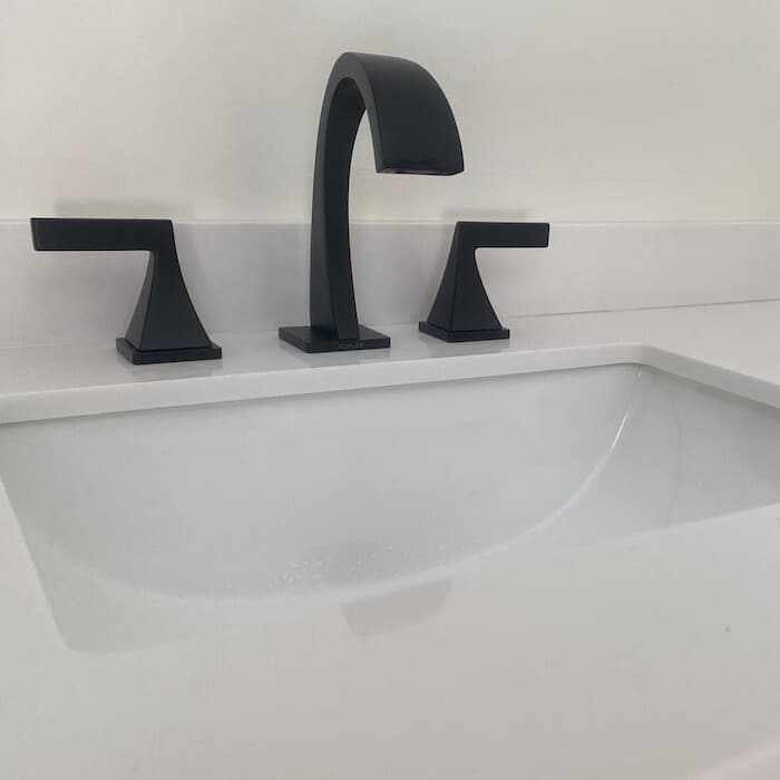 New faucet installation on white countertops