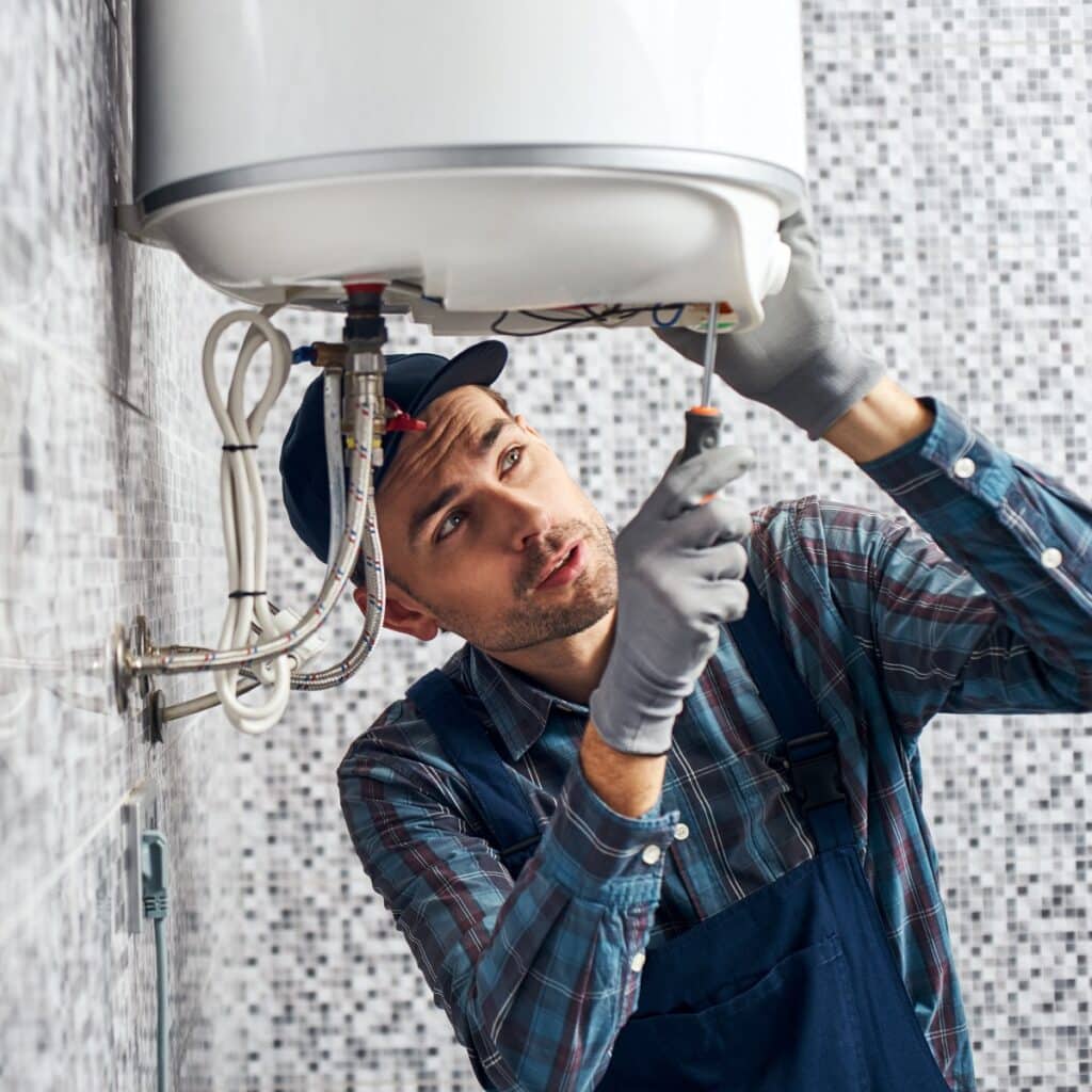 plumber setting up electric water heater
